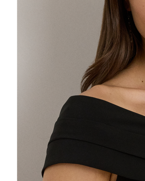 Smooth, delicate crepe creates a body-hugging silhouette in this cocktail dress, which is designed with an overlapping off-the-shoulder neckline for a style that is equal parts alluring and sophisticated.