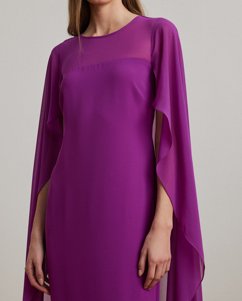 Turn heads at your next event in this glamorous georgette gown, which is designed with a floor-length, semi-sheer cape overlay and a statuesque column silhouette.