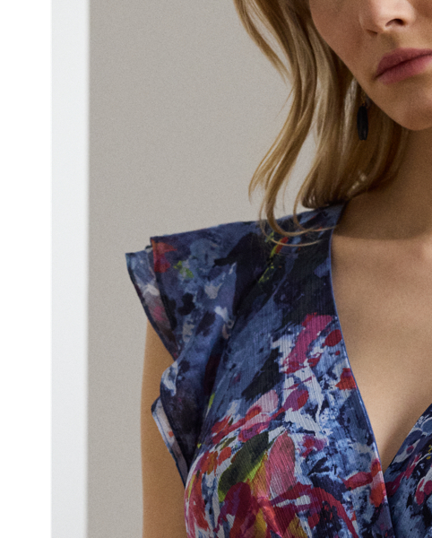 Showcasing the season's painterly abstract print, this floor-sweeping gown pairs crinkle georgette with cascading ruffles to create effortless movement with each step. Flutter sleeves amplify its enchanting sensibility, while a coordinating self-belt defines the waist.