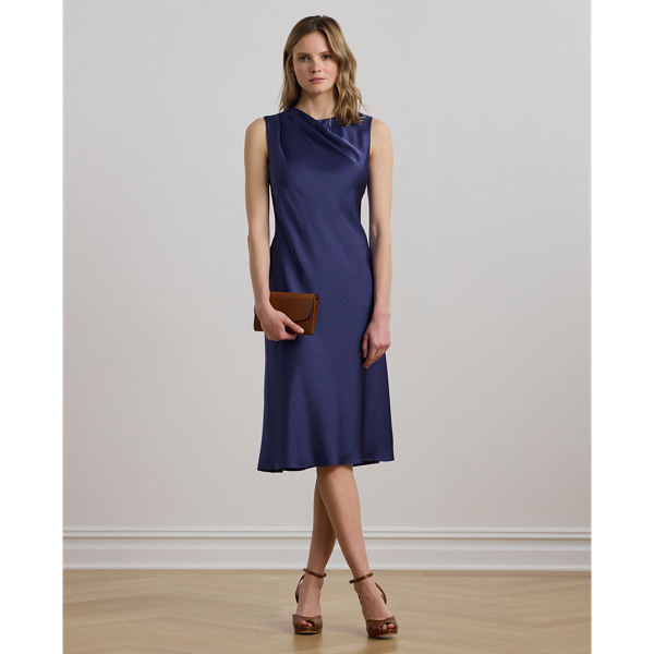 Satin charmeuse brings a beautiful sheen and graceful drape to this sleeveless cocktail dress, which is finished with elegant pleats on the shoulder.