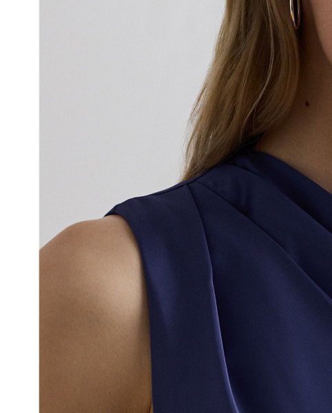 Satin charmeuse brings a beautiful sheen and graceful drape to this sleeveless cocktail dress, which is finished with elegant pleats on the shoulder.