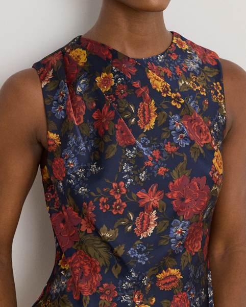 Satin charmeuse brings a beautiful sheen and graceful drape to this sleeveless cocktail dress, which depicts the season's painterly florals against a navy backdrop. Pleats on the shoulder provide an elegant finish.