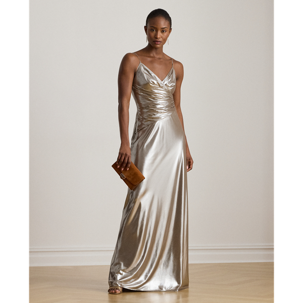 Turn heads in this floor-length sleeveless gown, which features a pleated surplice bodice and fluid metallic chiffon for a lustrous sheen.
