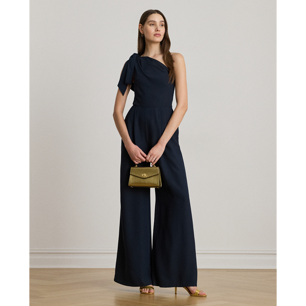 Satin-faced crepe brings an elegant drape to the wide-leg silhouette of this one-shoulder jumpsuit, while self-ties form a bow on the strap for a feminine finish.