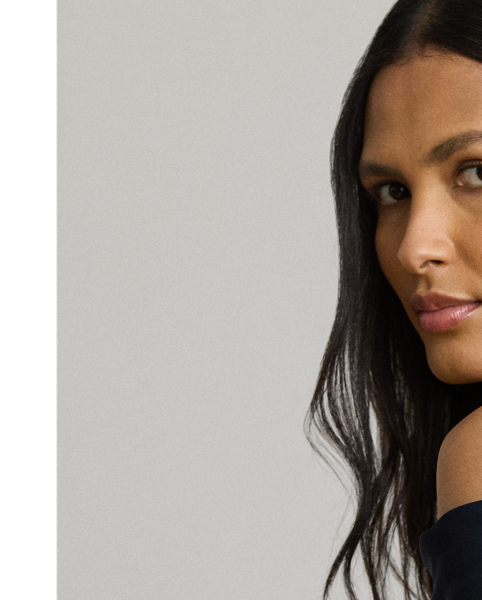 Evoking timeless glamour, this off-the-shoulder gown is designed with thoughtfully placed vertical seams, which accentuate its statuesque column silhouette. A slit on the skirt and smooth, stretch-infused crepe afford ease of movement.