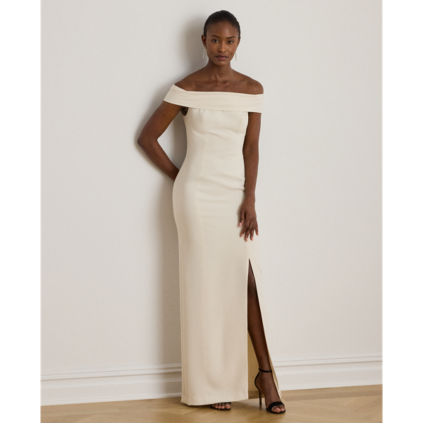 Evoking timeless glamour, this off-the-shoulder gown is designed with thoughtfully placed vertical seams, which accentuate its statuesque column silhouette. A slit on the skirt and smooth, stretch-infused crepe afford ease of movement.