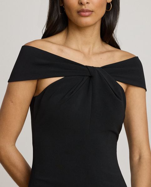 Distinguished by a twist-front off-the-shoulder neckline, this refined cocktail dress features a sheath silhouette crafted from smooth, stretch-infused crepe.
