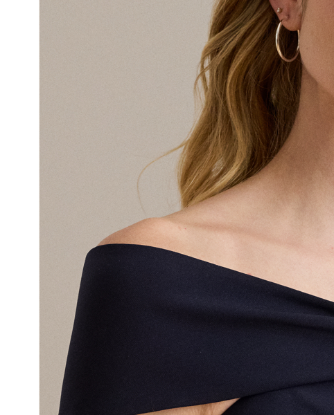 Distinguished by a twist-front off-the-shoulder neckline, this refined cocktail dress features a sheath silhouette crafted from smooth, stretch-infused crepe.