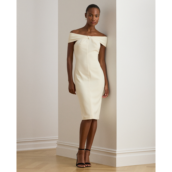 Distinguished by a twist-front off-the-shoulder neckline, this refined cocktail dress features a sheath silhouette crafted from smooth, stretch-infused crepe.