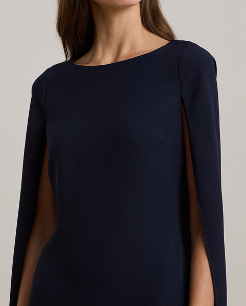 A stylish choice for special occasions, this modern georgette cocktail dress is elevated by a cascading cape, which adds fluid movement to its body-hugging silhouette.