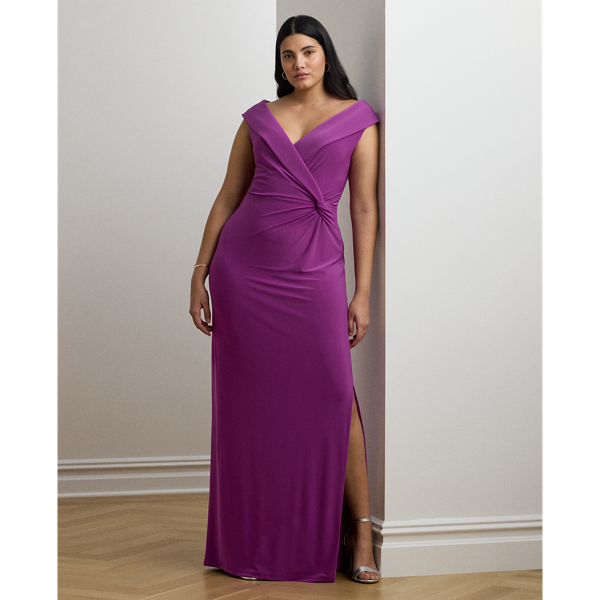 Crafted from smooth, body-hugging jersey, this column gown is designed with an elegant off-the-shoulder silhouette and a chic twist detail on the waist. A slit in the skirt creates ease of movement.