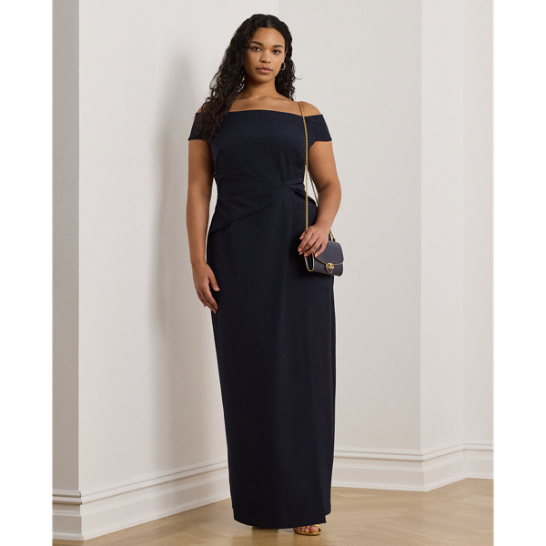 Crafted with smooth crepe for a fluid drape and a luxurious sensibility, this gown is designed with an elegant off-the-shoulder silhouette and a chic twist detail on the waist. A slit in the skirt creates ease of movement.