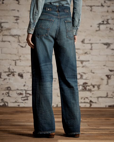 Relaxed-fitting, wide-leg jeans made with 12.75 oz. Japanese denim. 3x1 left-hand twill is dyed with true indigo. Dark high-contrast wash with an inky blue shade and hand-distressing creates an authentic vintage look. Adjustable buckled back and other detailing inspired by denim styles from the late 1930s.