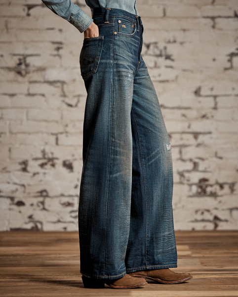 Relaxed-fitting, wide-leg jeans made with 12.75 oz. Japanese denim. 3x1 left-hand twill is dyed with true indigo. Dark high-contrast wash with an inky blue shade and hand-distressing creates an authentic vintage look. Adjustable buckled back and other detailing inspired by denim styles from the late 1930s.