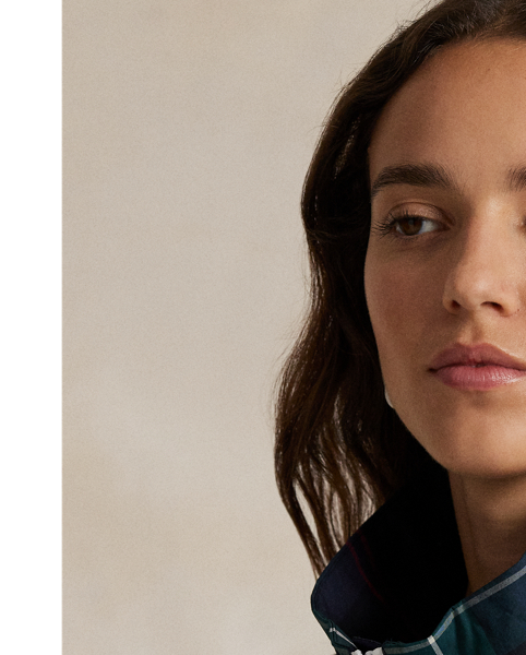 Designed to keep you shielded from wind and rain, this lightweight plaid jacket is made from water-repellent fabric and features a zip-off hood and a mesh-lined back vent for breathability.