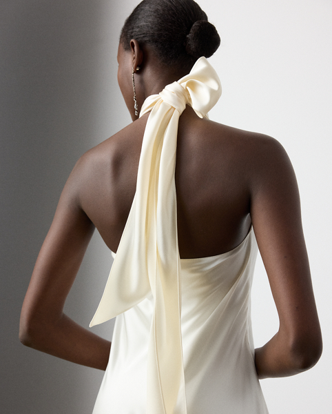 Originating in Spring 2023, the Chilton showcases Mr Lauren's ability to transform timeless silhouettes into modern designs. Crafted in Italy with stretch-infused satin, which is coveted for its beautiful sheen and fluid drape, this evening gown is distinguished by a halter silhouette with self-ties, which cascade beautifully down its dramatic open back.