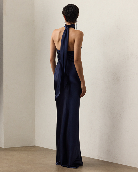 Originating in Spring 2023, the Chilton showcases Mr Lauren's ability to transform timeless silhouettes into modern designs. Crafted in Italy with stretch-infused satin, which is coveted for its beautiful sheen and fluid drape, this evening gown is distinguished by a halter silhouette with self-ties, which cascade beautifully down its dramatic open back.