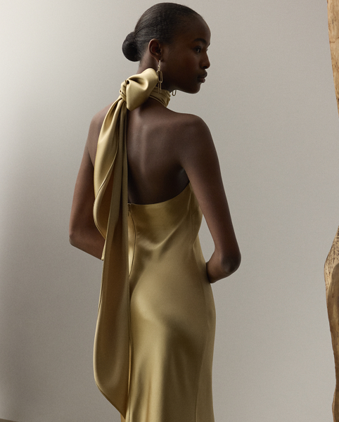 Originating in Spring 2023, the Chilton showcases Mr Lauren's ability to transform timeless silhouettes into modern designs. Crafted in Italy with stretch-infused satin, which is coveted for its beautiful sheen and fluid drape, this evening gown is distinguished by a halter silhouette with self-ties, which cascade beautifully down its dramatic open back.