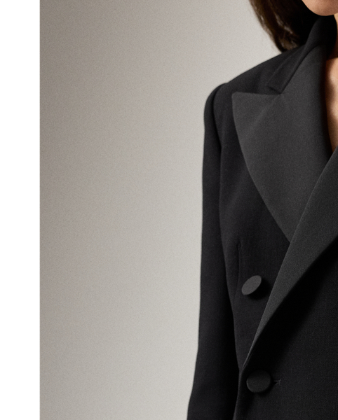 The double-breasted jacket, one of  Ralph Lauren Lauren's most enduring silhouettes, is re-imagined this season as a chic, thigh-grazing cocktail dress. Italian-made with double-faced wool and lined with our signature jacquard fabric, the Cottrell’s mini silhouette is tailored with traditional suiting elements, including silk faille peak lapels, flapped pockets and a welt pocket on the chest. Cut for a wider shoulder and fitted at the waist and skirt, this dress is finished with silk faille-covered buttons on the placket and the sleeves.
