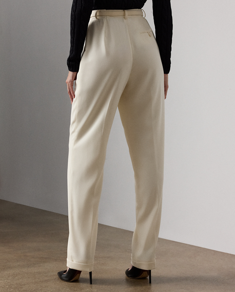 A wider-leg version of our iconic Stamford trouser, the Acklie, which is designed with front pleats and crisp leg creases, is a classic example of Ralph Lauren Lauren's signature menswear-inspired trousers for women. Its wool gabardine fabric, woven in a revered Italian mill, produces its soft hand and attractive drape. A self-belt elevated by a petite square-shaped buckle creates definition at the waist, while a high-rise fit evokes a strong feminine aesthetic.