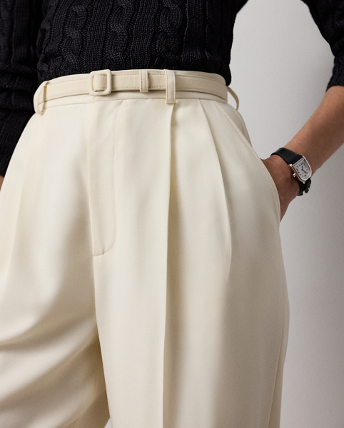 A wider-leg version of our iconic Stamford trouser, the Acklie, which is designed with front pleats and crisp leg creases, is a classic example of Ralph Lauren Lauren's signature menswear-inspired trousers for women. Its wool gabardine fabric, woven in a revered Italian mill, produces its soft hand and attractive drape. A self-belt elevated by a petite square-shaped buckle creates definition at the waist, while a high-rise fit evokes a strong feminine aesthetic.