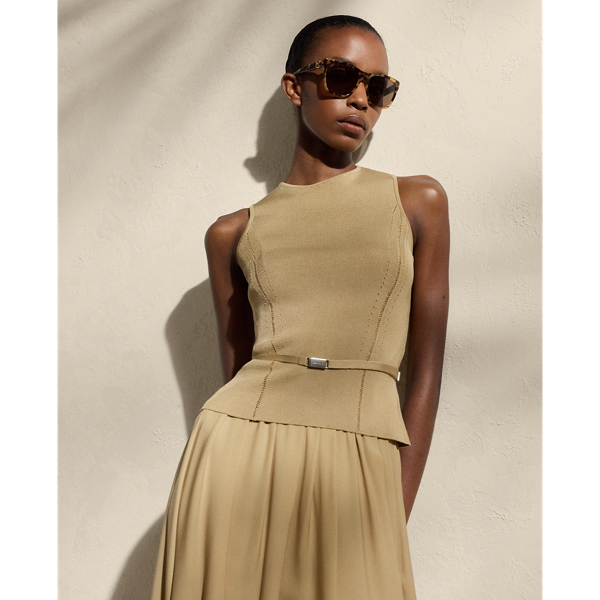 Cut for a sleeveless silhouette, this crewneck jumper is spun with a high-shine filament silk knit with a stretch yarn, resulting in a fabric that balances a soft drape with a flattering structure. Fagoted princess seams and a buckled self-belt enhance the natural curves of the waist.