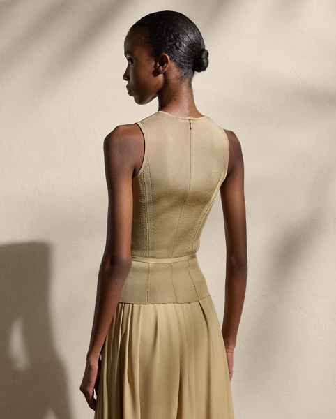 Cut for a sleeveless silhouette, this crewneck jumper is spun with a high-shine filament silk knit with a stretch yarn, resulting in a fabric that balances a soft drape with a flattering structure. Fagoted princess seams and a buckled self-belt enhance the natural curves of the waist.