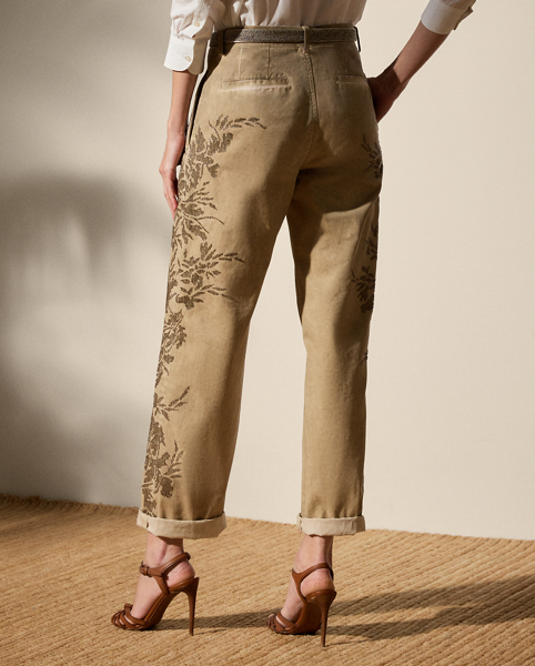 A timeless wardrobe staple, the Fallon modernises the essential chino trouser with a relaxed fit, welt pockets and a flattering mid-rise. Crafted from 100% Italian cotton twill, which is woven with a left hand and specially washed with cold pigment for added softness and a timeworn appearance, this version undergoes a unique artisanal process to achieve its final look. Using a special dyeing method to create irregular colouring, this pair is embroidered by four technicians with a traditional Aari technique, carefully placing each bead and metallic thread to recreate a floral motif that follows this style's dyed effect.