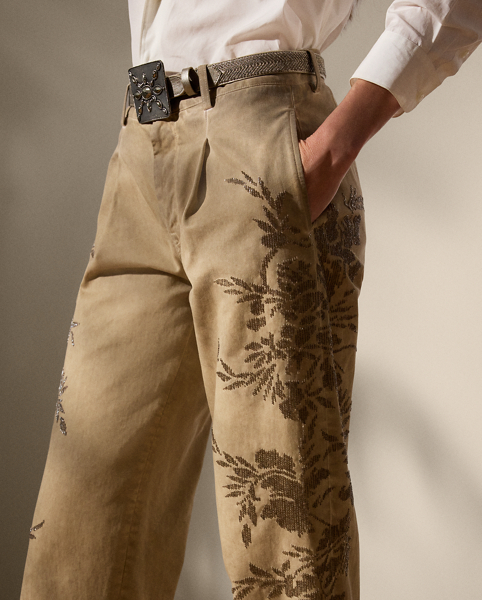 A timeless wardrobe staple, the Fallon modernises the essential chino trouser with a relaxed fit, welt pockets and a flattering mid-rise. Crafted from 100% Italian cotton twill, which is woven with a left hand and specially washed with cold pigment for added softness and a timeworn appearance, this version undergoes a unique artisanal process to achieve its final look. Using a special dyeing method to create irregular colouring, this pair is embroidered by four technicians with a traditional Aari technique, carefully placing each bead and metallic thread to recreate a floral motif that follows this style's dyed effect.