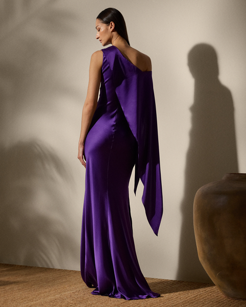 An embodiment of ethereal beauty, the Lizzie evening dress is crafted from stretch silk charmeuse for a beautiful hand and an effortless drape. Bias-cut with a slim silhouette, this dress is distinguished by a cascading ruffle, which starts at the neckline then continues down the arm to create a long sleeve. A skirt slit on the right side seam offers ease of movement.