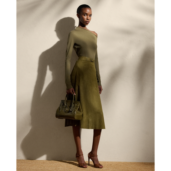 A refreshed rendition of the A-line skirt, the calf-sweeping Kensley is designed with a buckled waistband embellished with lamb-suede grommets and antiqued metal hardware. A lightweight lamb-suede fabrication with subtle perforations throughout is selected for its luxurious yet sporty sensibility, while a silk georgette lining offers comfort.