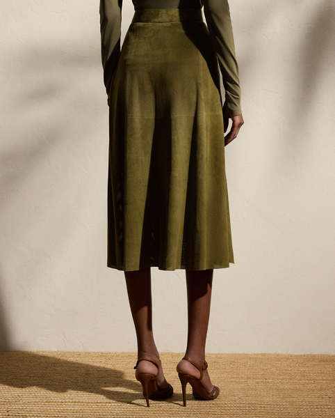 A refreshed rendition of the A-line skirt, the calf-sweeping Kensley is designed with a buckled waistband embellished with lamb-suede grommets and antiqued metal hardware. A lightweight lamb-suede fabrication with subtle perforations throughout is selected for its luxurious yet sporty sensibility, while a silk georgette lining offers comfort.