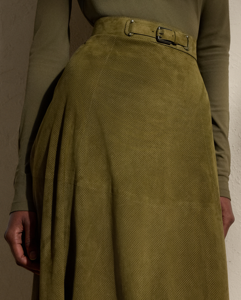A refreshed rendition of the A-line skirt, the calf-sweeping Kensley is designed with a buckled waistband embellished with lamb-suede grommets and antiqued metal hardware. A lightweight lamb-suede fabrication with subtle perforations throughout is selected for its luxurious yet sporty sensibility, while a silk georgette lining offers comfort.