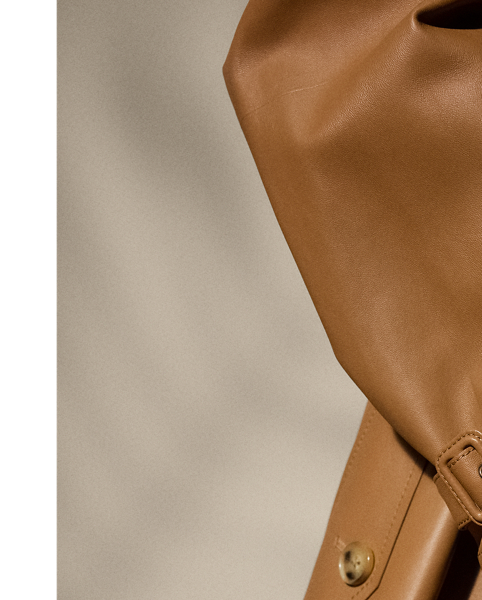 The Italian-made Niles is designed with traditional trench coat details, including buttoned shoulder epaulettes, storm flaps, a belted collar and waist and a double-breasted silhouette, and is made from supple nappa lambskin for a luxurious look. Imitation horn buttons, lambskin-covered buckles and a debossed logo on the undercollar add refinement to its timeless design.