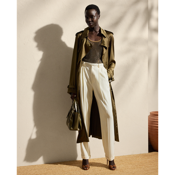 The Italian-made Carlton is designed with traditional trench coat details, including buttoned shoulder epaulettes, storm flaps, a buckled throatlatch, a belted waist and a double-breasted silhouette and is crafted from water-repellent, washed satin charmeuse for a remarkable drape and a soft hand feel. Genuine mother-of-pearl buttons and lamb-suede-covered buckles add refinement to its timeless design.