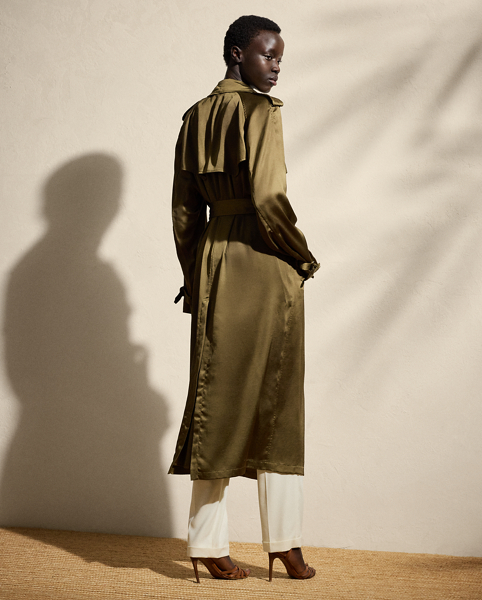 The Italian-made Carlton is designed with traditional trench coat details, including buttoned shoulder epaulettes, storm flaps, a buckled throatlatch, a belted waist and a double-breasted silhouette and is crafted from water-repellent, washed satin charmeuse for a remarkable drape and a soft hand feel. Genuine mother-of-pearl buttons and lamb-suede-covered buckles add refinement to its timeless design.
