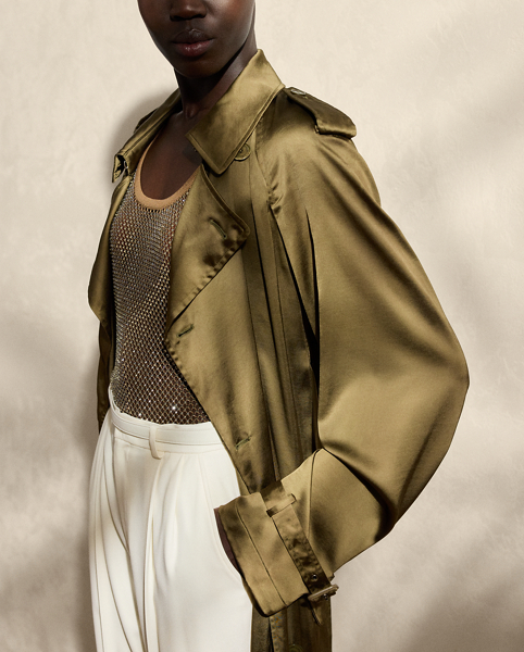 The Italian-made Carlton is designed with traditional trench coat details, including buttoned shoulder epaulettes, storm flaps, a buckled throatlatch, a belted waist and a double-breasted silhouette and is crafted from water-repellent, washed satin charmeuse for a remarkable drape and a soft hand feel. Genuine mother-of-pearl buttons and lamb-suede-covered buckles add refinement to its timeless design.