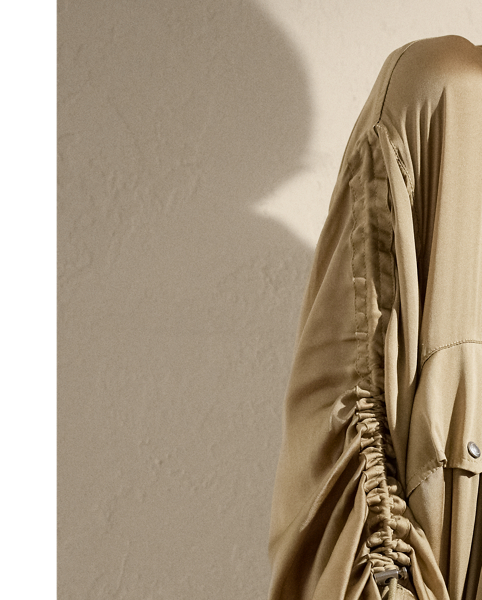 Crafted with ultrafine, semi-sheer silk charmeuse, which is beautifully finished for a fluid drape, the Amberly is designed with an array of parachute-style details, including multiple drawcords throughout, signature hardware and a funnelneck. Intended to hit above the ankle, this long coat is cut for a slightly oversize, relaxed fit.