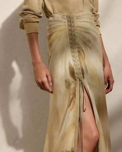 Crafted with airy silk gauze printed with the season's dreamy floral motif, which originated as a watercolour painting done by one of Ralph Lauren Lauren's skilled artists, our Odera evening skirt is distinguished by fixed ruching and a lace-up lamb-suede placket, which continues down the side and releases into a skirt slit for ease of movement.
