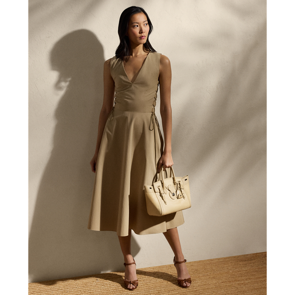 Crafted in Italy from 100% cotton gabardine – a compact yet supple fabrication, which strikes the perfect balance between structure and a soft, lightweight hand feel – the Renna dress is cut for a calf-grazing A-line silhouette and features utility-inspired lace-up detailing on the bodice.