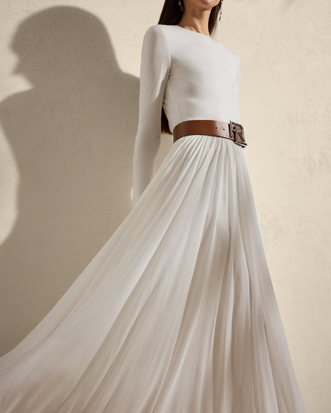 Beautifully understated, this sweeping day dress is crafted with crepe jersey for a flattering fit and a lightweight feel. Its body-skimming bodice is cinched at the waist with a belt, while delicate shirring at the waist and skirt affords effortless elegance.