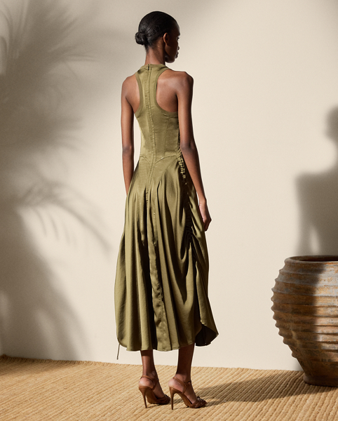 The Sienna day dress is designed with an array of considered details, including a halter neckline, a racerback, rounded skirt panels and triple-needle topstitching. Cut for a calf-grazing length, this A-line style features adjustable drawcords at the side seams for a ruched appearance. This style is crafted with lustrous, washed satin charmeuse for a remarkable drape and soft hand feel.