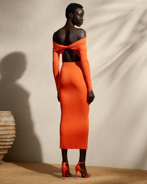 A timeless wardrobe staple, this midi-length knitted cocktail dress is designed with a fold-over off-the-shoulder neckline, long sleeves and a refined twist-back detail. Compact, lightweight jersey in the season’s vibrant orange hue offers a sculpted, flattering fit.