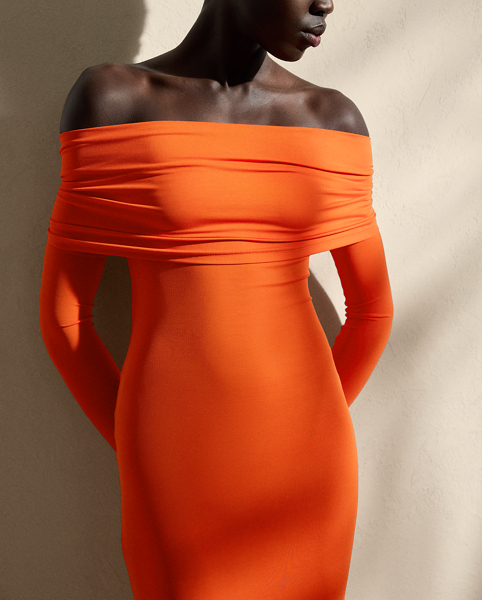 A timeless wardrobe staple, this midi-length knitted cocktail dress is designed with a fold-over off-the-shoulder neckline, long sleeves and a refined twist-back detail. Compact, lightweight jersey in the season’s vibrant orange hue offers a sculpted, flattering fit.