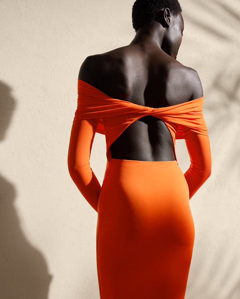 A timeless wardrobe staple, this midi-length knitted cocktail dress is designed with a fold-over off-the-shoulder neckline, long sleeves and a refined twist-back detail. Compact, lightweight jersey in the season’s vibrant orange hue offers a sculpted, flattering fit.