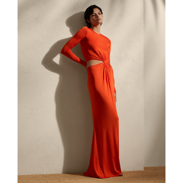 This glamorous evening gown is carefully crafted in Italy with a shiny viscose blend selected for its excellent drape and sheen. Distinguished by the season’s vibrant orange hue, this long-sleeve dress is detailed with a twist-front accent and a subtle cutout on the waist, creating a style that embodies understated elegance.