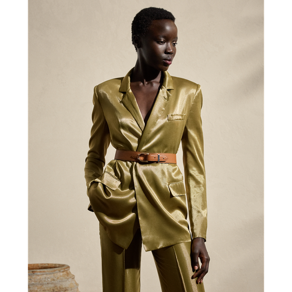 Melding the soft construction of a men's robe with the design elements of a structured blazer, the Quinton is  Ralph Lauren Lauren's modern rendition of a women's smoking jacket. Made in Italy with a luxurious satin fabrication that was specially developed with metallicised yarns woven on a fine silk-blend warp to achieve a fluid metal effect, this jacket is finished with a self-belt that's intended to be knotted at the waist.