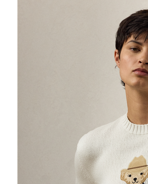 Capturing the relaxed sophistication of the Hamptons, the Spring 2025 Collection's blue-and-white colour palette nods to the interplay between sky and sea, which is brought to life here in the season's lofty silk Polo Bear jumper. Donning an outfit informed by Mr Lauren's penchant for Western style, the Hamptons Spring Polo Bear was created by a master embroiderer from highly considered materials, including rustic lamb suede for the season's Western-inspired Rennie jacket, silk jersey for the striped T-shirt, cotton broadcloth for the shirt, washed linen-blend canvas for the trousers, silk double georgette for the bandanna, dry-cleanable lamb suede for the cowboy boots and cowboy hat, and metallic thread for the  Ralph Lauren Lauren Collection's signature rodeo-buckle belt.