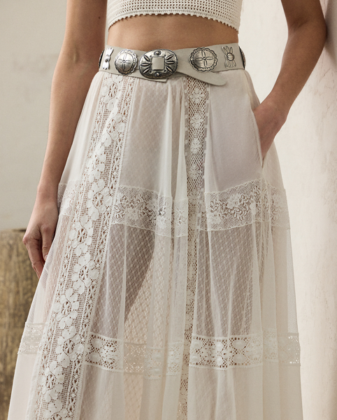 Striking a balance between elegance and rusticity, the Malti skirt's maxi-length silhouette is constructed with a series of panels and luxurious layers. A mesh lace fabric serves as the under layer, while alternating panels of sheer cotton-and-silk voile and tulle unite with hand-embroidered lace to create the exterior fabric. Crafted in Italy, this style is equipped with side on-seam pockets and a cotton lining for opacity.