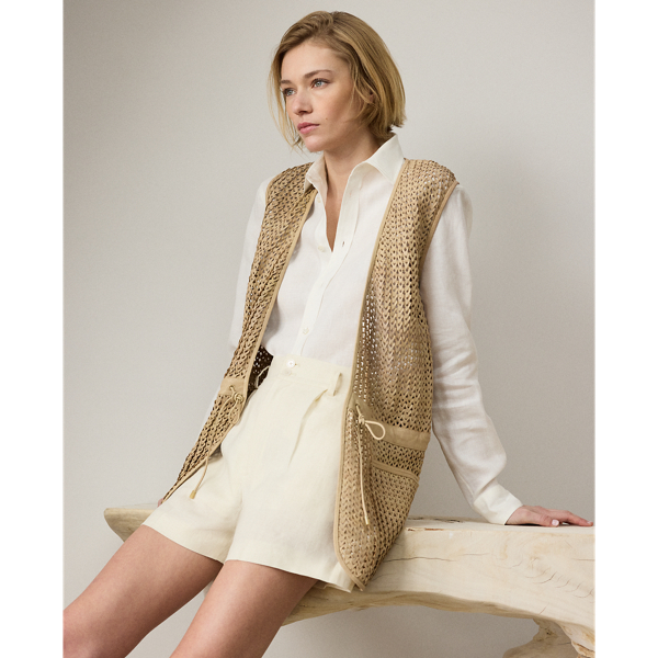 Utilising the dedicated crafting of eight highly skilled artisans, the Tabetha waistcoat undergoes a multi-step artisanal process to achieve its unique silhouette. To begin, the graphic designer and the pattern department collaborate to create the pattern paper used for this style. Experienced cutters select the highest quality skins for this piece, cutting the leather into 5 cm strips and weaving them together by hand to follow the pattern placement and form the panels that make up the waistcoat's timeless design. Finally, tonal lambskin piping is applied to frame the garment. Additional touches, including a lamb-suede drawcord with "RL"-engraved imitation horn cord ends and besom pockets, complete the look.